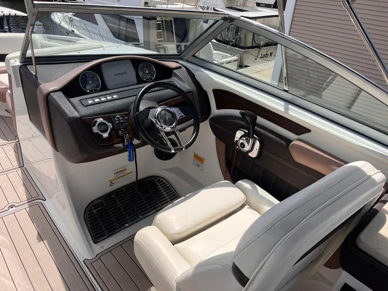 Slide: The Image of 2013 Cobalt 24SD boat cockpit with steering wheel and Garmin display. - 31