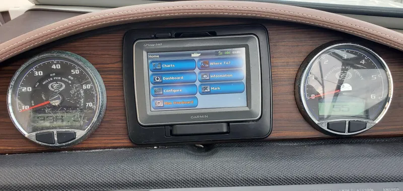 Slide: The Image of Dashboard of a 2013 Cobalt 24SD boat with Garmin GPS and analog gauges. - 32