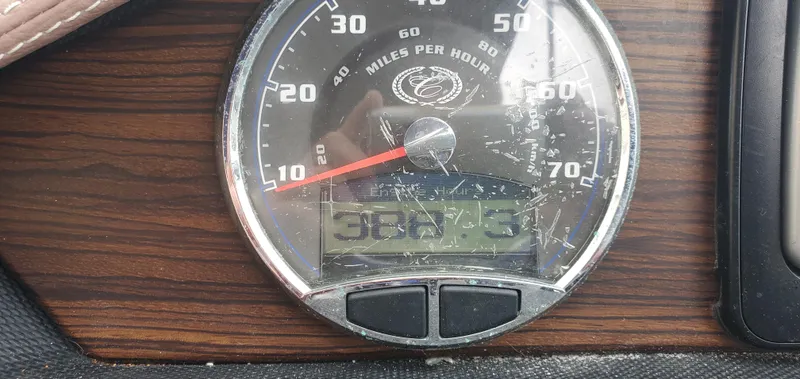 Slide: The Image of Speedometer of 2013 Cobalt 24SD boat showing 388.3 hours on wooden dashboard. - 34