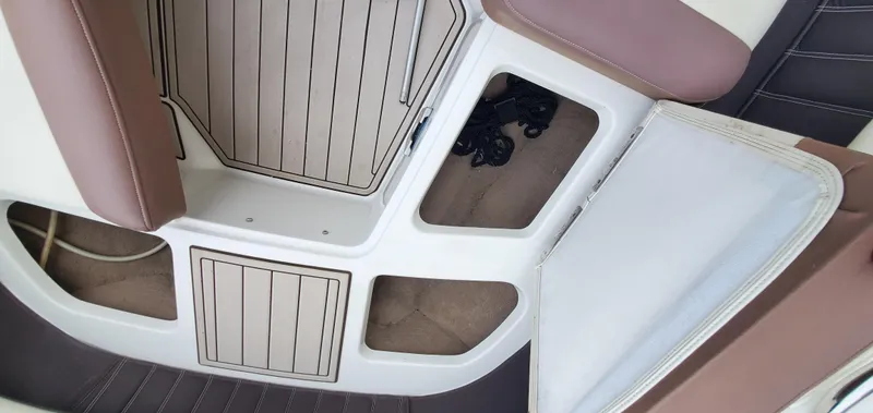 Slide: The Image of Interior of a 2013 Cobalt 24SD boat showing seating and storage compartments. - 39