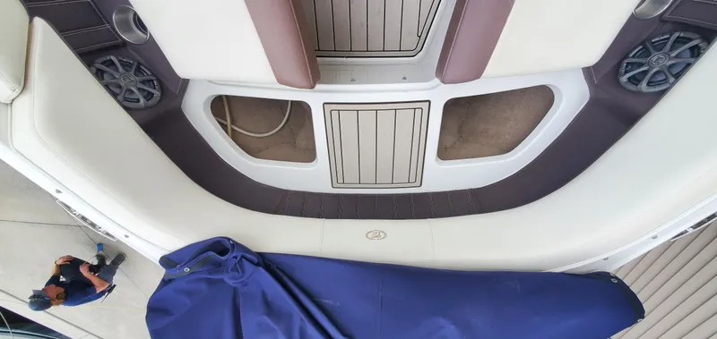 Slide: The Image of Interior view of a 2013 Cobalt 24SD boat with seating and storage compartments. - 40