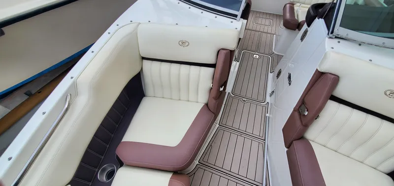 Slide: The Image of 2013 Cobalt 24SD boat interior with white and brown seating, teak-style flooring. - 42