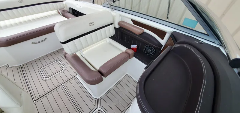 Slide: The Image of Interior of a 2013 Cobalt 24SD boat with luxurious seating and cup holder. - 45