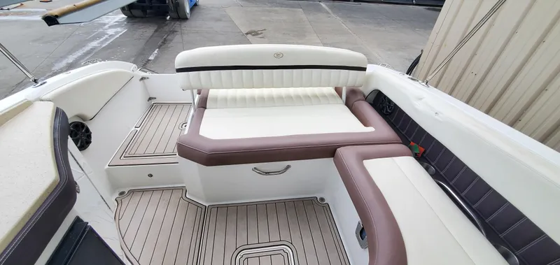 Slide: The Image of 2013 Cobalt 24SD boat interior with white and brown seating, teak flooring. - 49