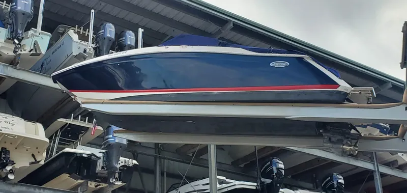 Slide: The Image of 2013 Cobalt 24SD boat stored on a rack in a marina. - 5