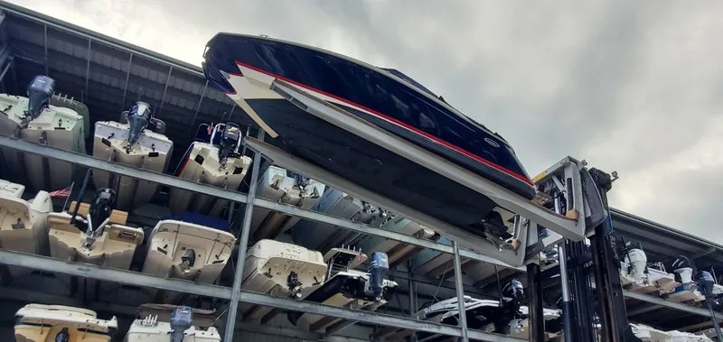 Slide: The Image of 2013 Cobalt 24SD boat stored on a rack in a marina. - 6