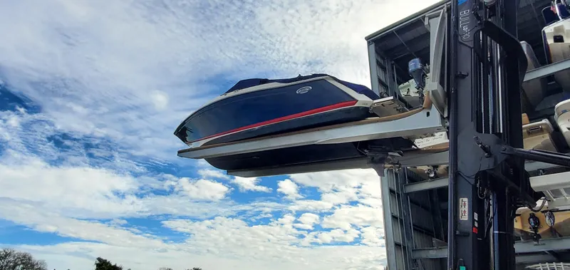 Slide: The Image of 2013 Cobalt 24SD boat on forklift against a cloudy blue sky. - 7
