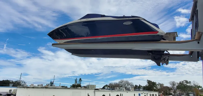 Slide: The Image of 2013 Cobalt 24SD boat on lift against blue sky background. - 8