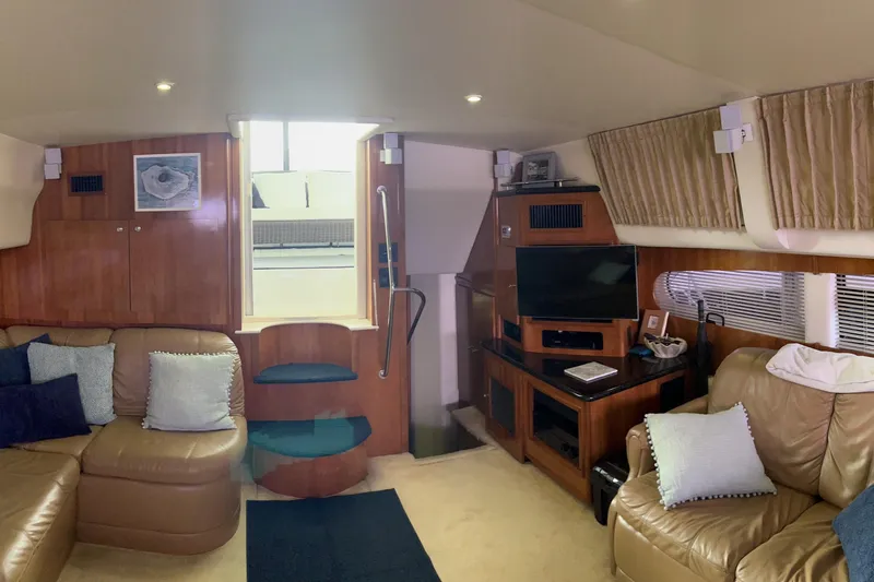 Slide: The Image of Luxurious interior of 2002 Carver 466 Motor Yacht with plush seating and entertainment center. - 17
