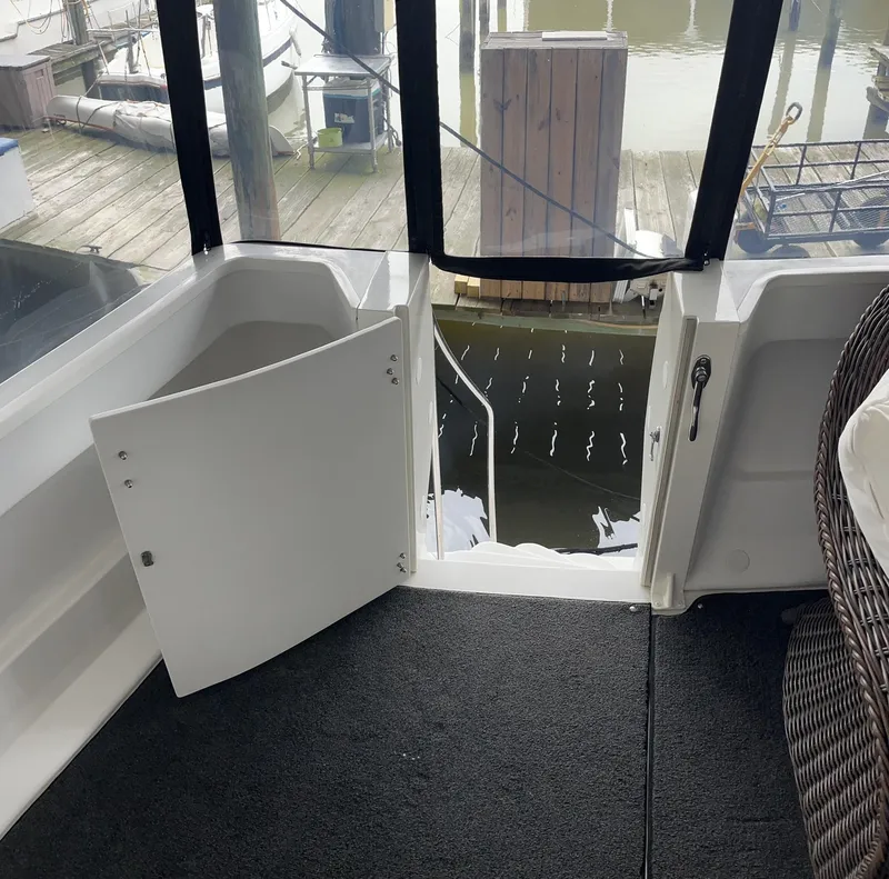 Slide: The Image of 2002 Carver 466 Motor Yacht interior with open door, dock view, and carpeted floor. - 18