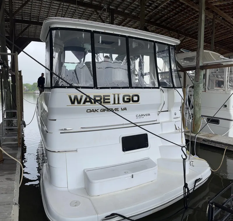Slide: The Image of 2002 Carver 466 Motor Yacht docked in marina, rear view. - 2