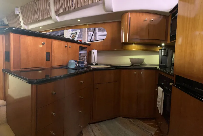 Slide: The Image of Luxurious kitchen interior of 2002 Carver 466 Motor Yacht with wooden cabinetry and modern appliances. - 20