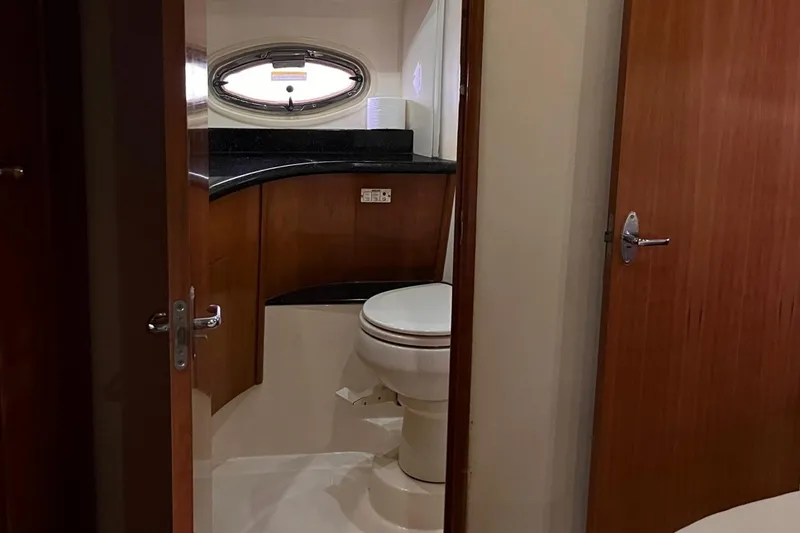 Slide: The Image of Bathroom interior of 2002 Carver 466 Motor Yacht with wooden cabinetry and oval window. - 28