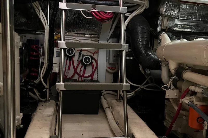 Slide: The Image of Engine room of 2002 Carver 466 Motor Yacht with ladder and mechanical components. - 42