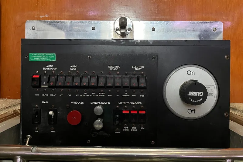 Slide: The Image of Control panel of a 2002 Carver 466 Motor Yacht with various switches and dials. - 44