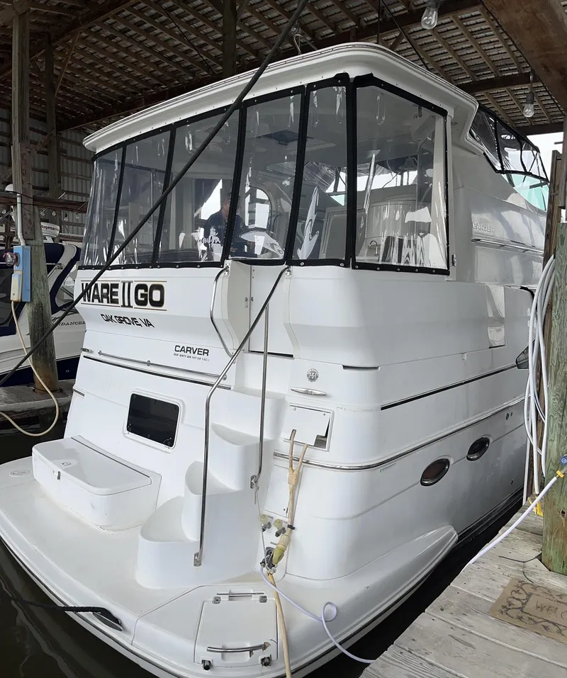 Slide: The Image of 2002 Carver 466 Motor Yacht docked in a covered marina. - 5