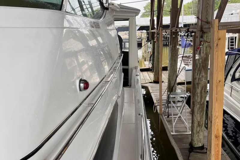 Slide: The Image of 2002 Carver 466 Motor Yacht docked in a marina, side view. - 7