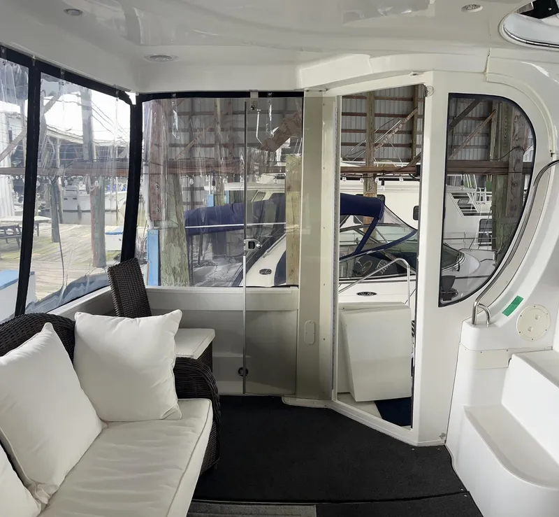 Slide: The Image of Interior of 2002 Carver 466 Motor Yacht with seating and glass doors. - 11