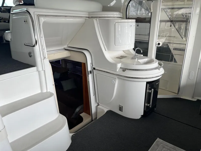 Slide: The Image of 2002 Carver 466 Motor Yacht interior with stairs, sink, and door. - 12