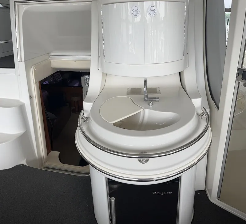 Slide: The Image of 2002 Carver 466 Motor Yacht interior with compact sink and storage area. - 13