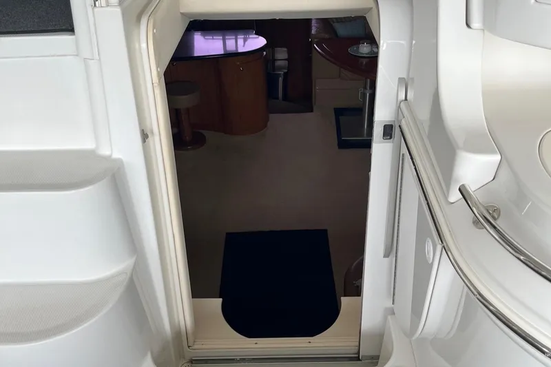 Slide: The Image of 2002 Carver 466 Motor Yacht interior entrance with visible seating and table. - 15