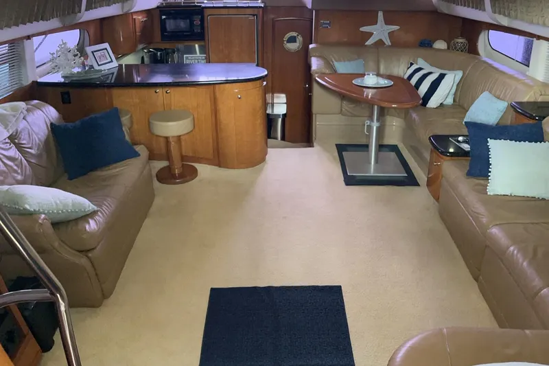 Slide: The Image of Interior of 2002 Carver 466 Motor Yacht with cozy seating and modern amenities. - 16