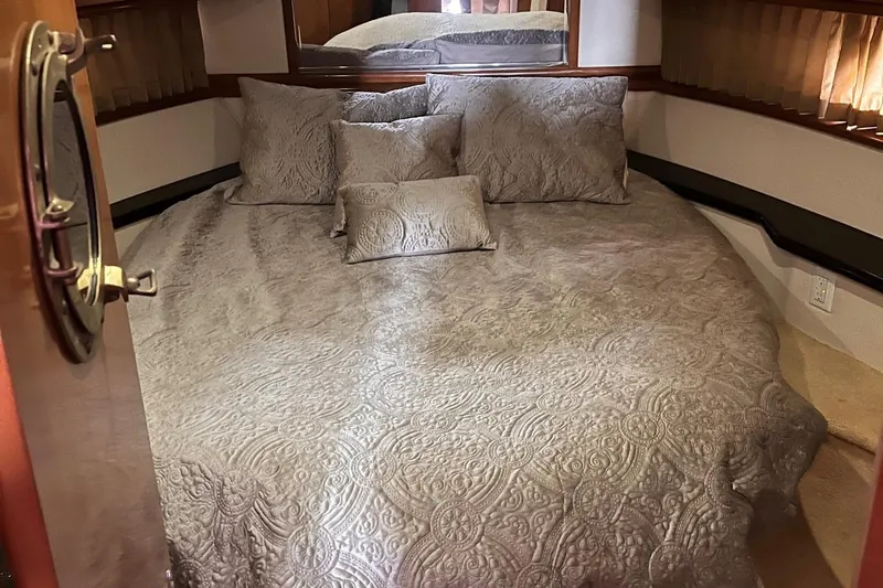 Slide: The Image of Luxurious bedroom in 2002 Carver 466 Motor Yacht with elegant bedding and cozy ambiance. - 22