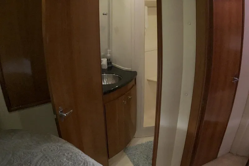 Slide: The Image of Interior of 2002 Carver 466 Motor Yacht showing bathroom with wooden cabinetry and sink. - 23