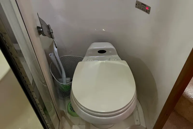 Slide: The Image of Toilet in 2002 Carver 466 Motor Yacht bathroom, featuring compact design and modern fixtures. - 25