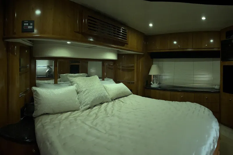 Slide: The Image of Luxurious bedroom interior of 2002 Carver 466 Motor Yacht with cozy bedding. - 26