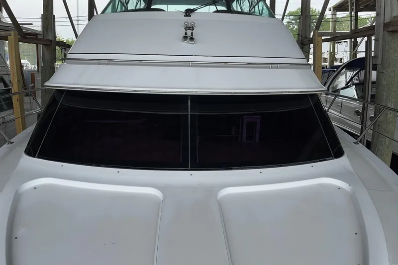 Slide: The Image of 2002 Carver 466 Motor Yacht with sleek design and tinted windows, docked in a marina. - 3