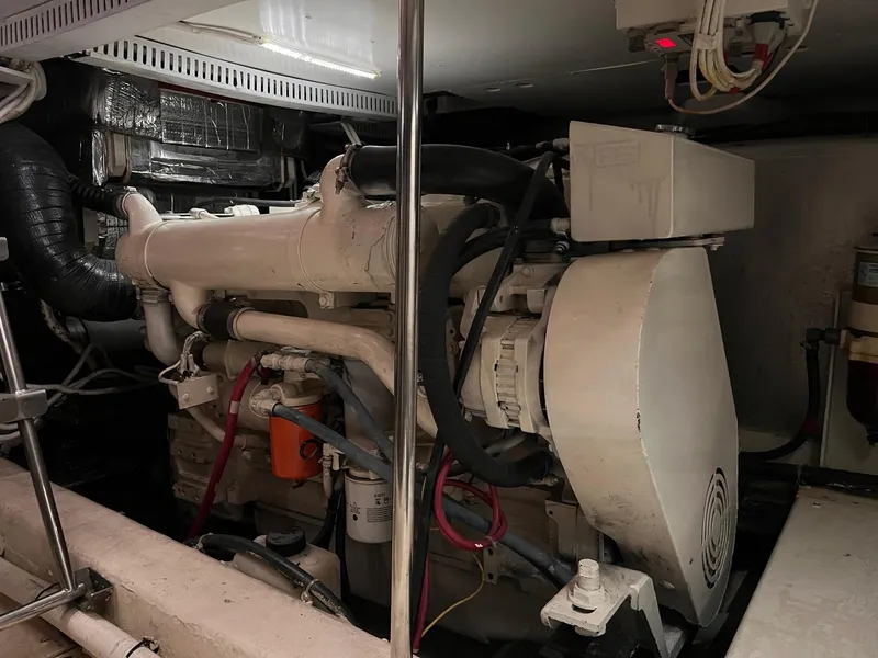 Slide: The Image of Engine room of a 2002 Carver 466 Motor Yacht, showcasing mechanical components and wiring. - 35