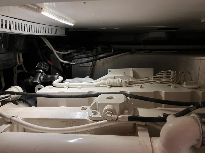 Slide: The Image of Engine room of a 2002 Carver 466 Motor Yacht, showcasing mechanical components and wiring. - 37