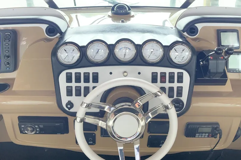 Slide: The Image of Control panel of a 2002 Carver 466 Motor Yacht with gauges and steering wheel. - 39