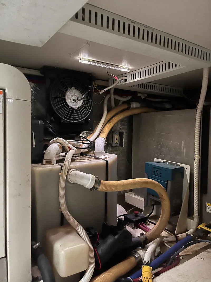 Slide: The Image of Engine room of 2002 Carver 466 Motor Yacht with visible hoses and equipment. - 45