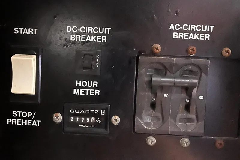 Slide: The Image of Control panel of a 2002 Carver 466 Motor Yacht with circuit breakers and hour meter. - 46