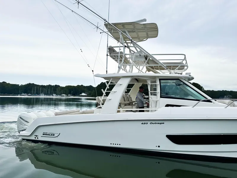 Slide: The Image of 2017 Boston Whaler 420 Outrage boat cruising on calm water. - 15
