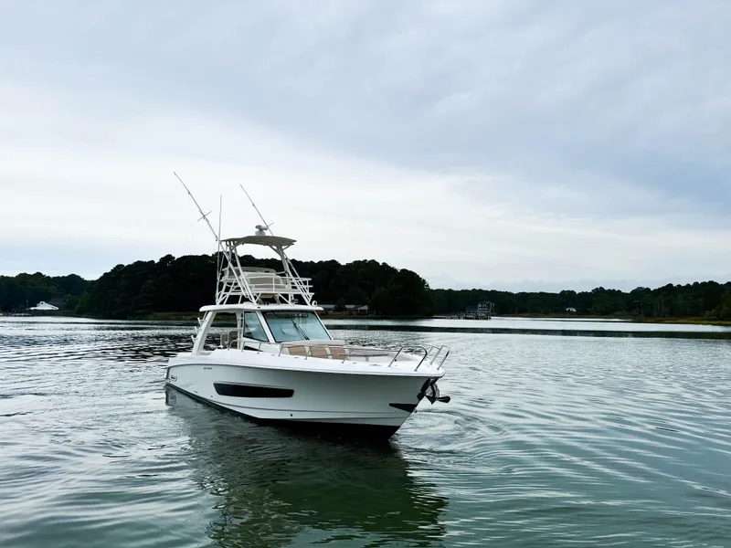 Slide: The Image of 2017 Boston Whaler 420 Outrage boat on calm water, overcast sky. - 17