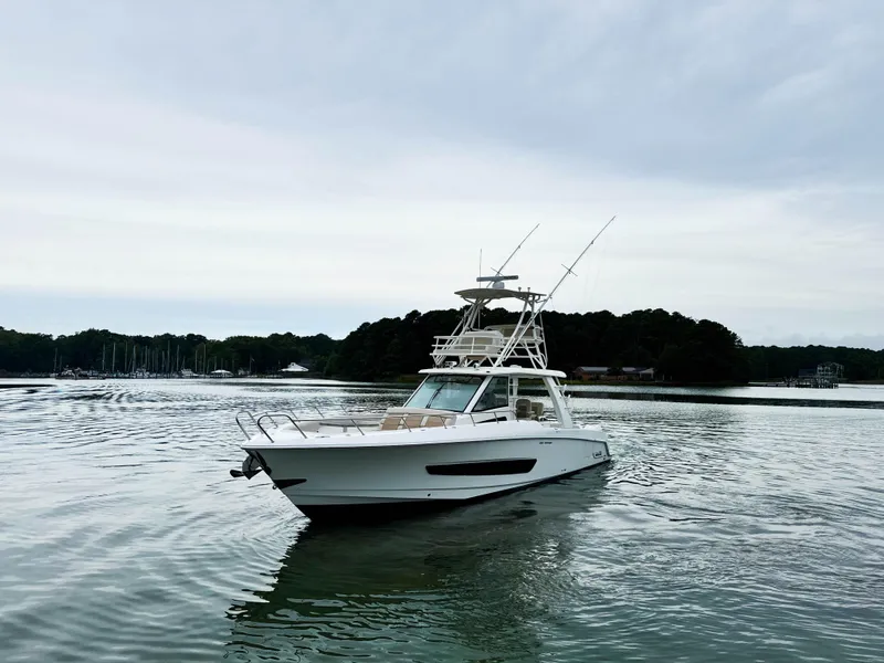 Slide: The Image of 2017 Boston Whaler 420 Outrage boat on calm water under cloudy sky. - 18