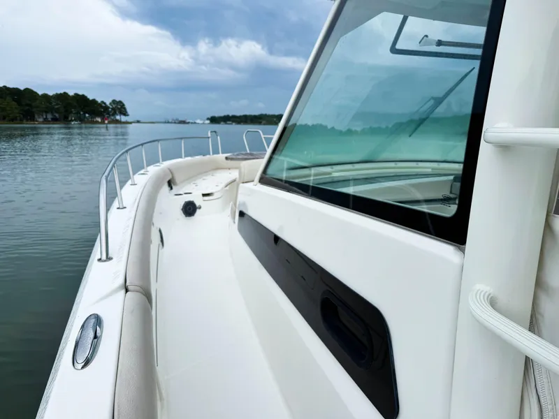 Slide: The Image of 2017 Boston Whaler 420 Outrage boat on calm water under cloudy sky. - 21
