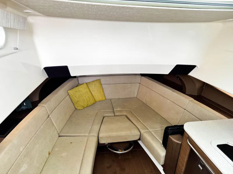 Slide: The Image of Interior of 2017 Boston Whaler 420 Outrage with beige seating and yellow cushion. - 22