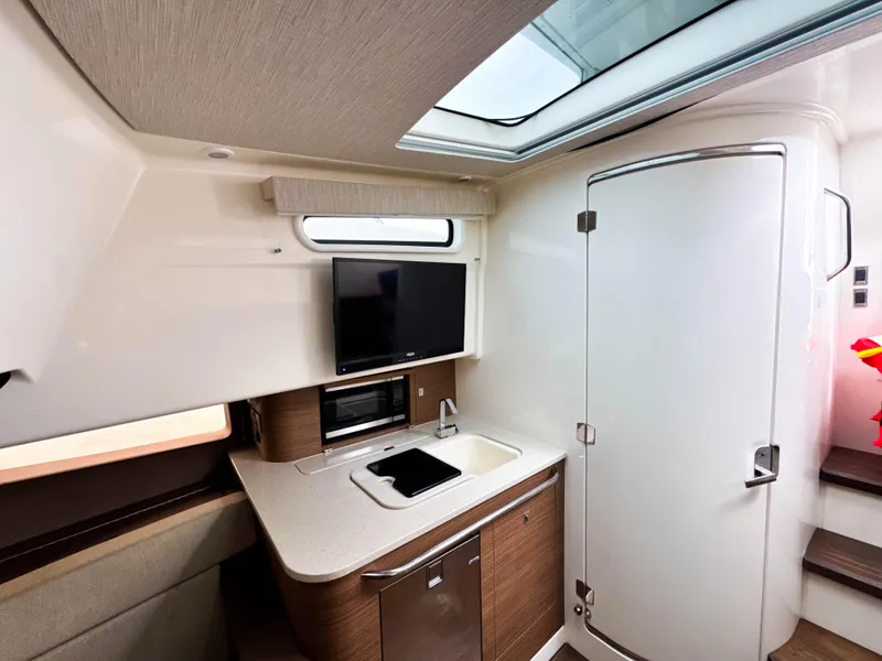 Slide: The Image of Interior of 2017 Boston Whaler 420 Outrage, featuring modern kitchenette and sleek design. - 27