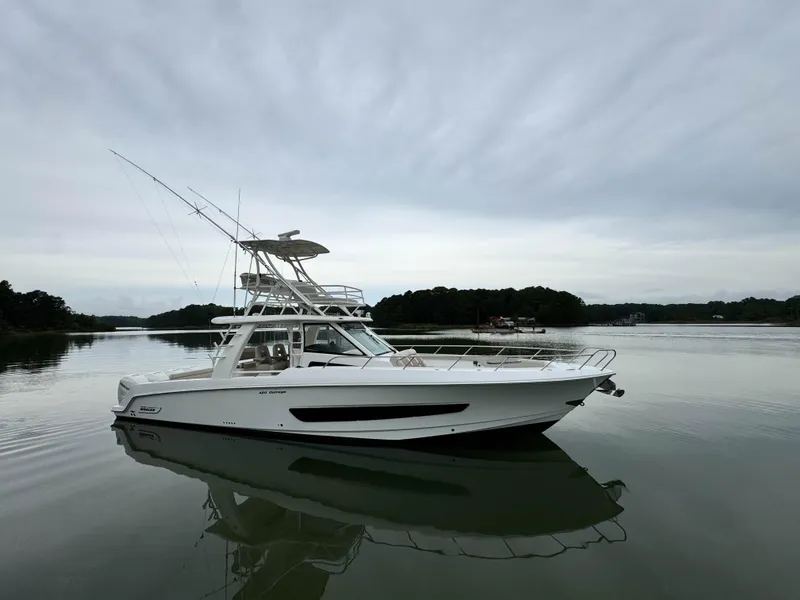Slide: The Image of 2017 Boston Whaler 420 Outrage boat on calm water, overcast sky. - 3