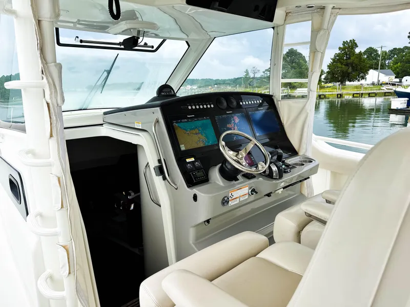 Slide: The Image of 2017 Boston Whaler 420 Outrage helm with advanced navigation displays and luxurious seating. - 32