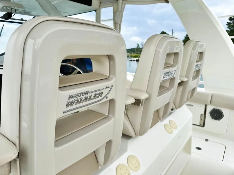 Slide: The Image of 2017 Boston Whaler 420 Outrage boat seats with logo, showcasing luxury marine design. - 35