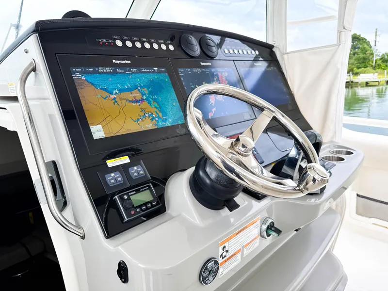 Slide: The Image of 2017 Boston Whaler 420 Outrage helm with dual navigation screens and steering wheel. - 37
