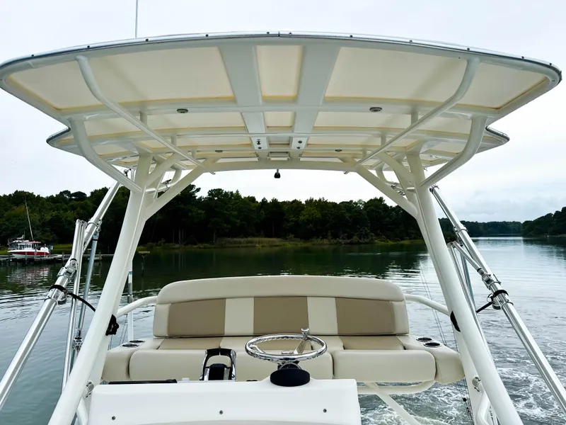 Slide: The Image of 2017 Boston Whaler 420 Outrage boat on calm water, featuring a spacious helm and canopy. - 43