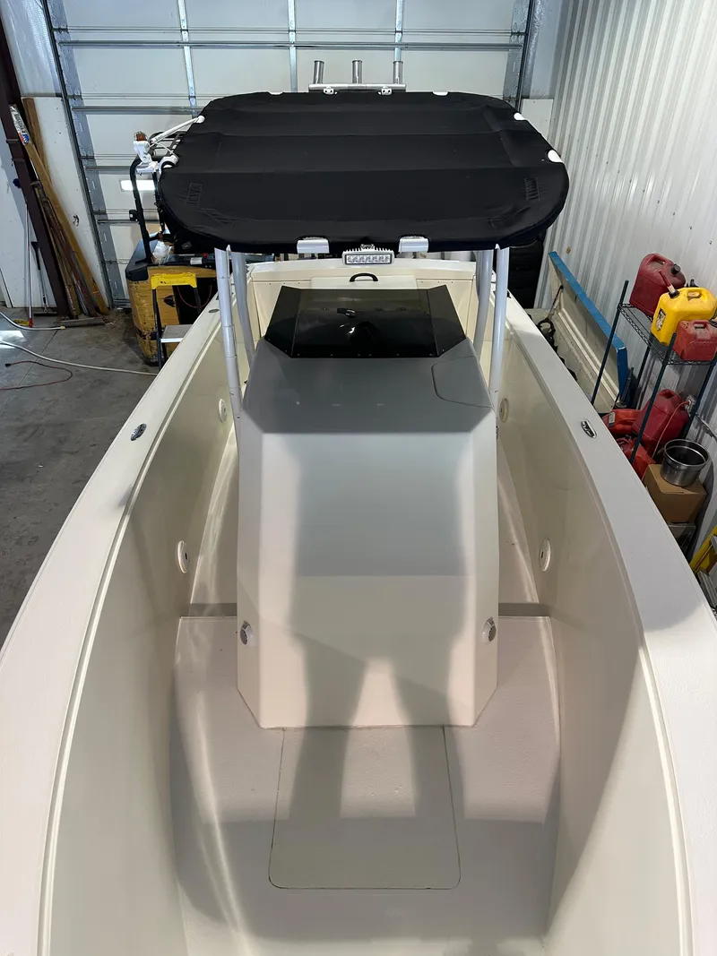 Slide: The Image of 1974 Donzi Center Console boat in a garage, featuring a sleek design and black canopy. - 2
