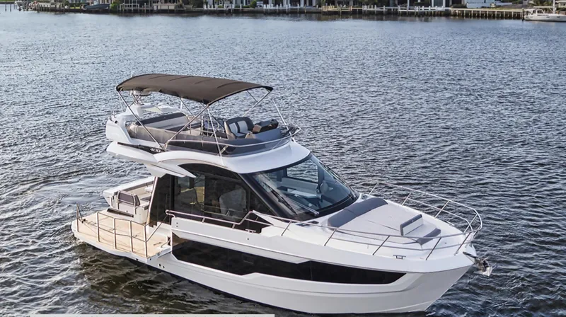 Slide: The Image of 2024 Galeon 400 Fly yacht cruising on a calm lake. - 4