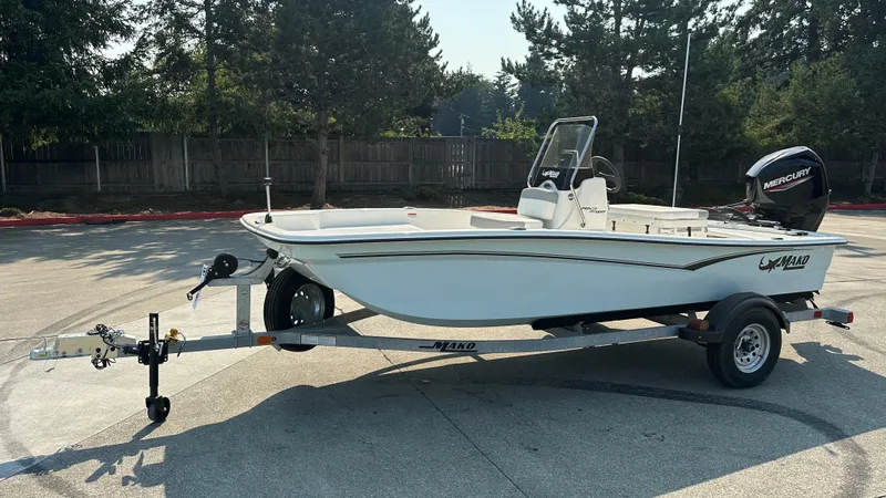 The Image of 2024 Mako Pro Skiff 15 CC boat on trailer in parking lot. - 0